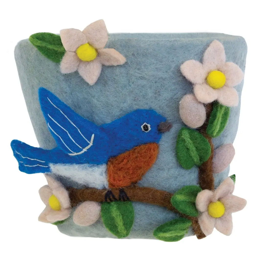 Felted planter with a blue bird and flowers on a light blue background
