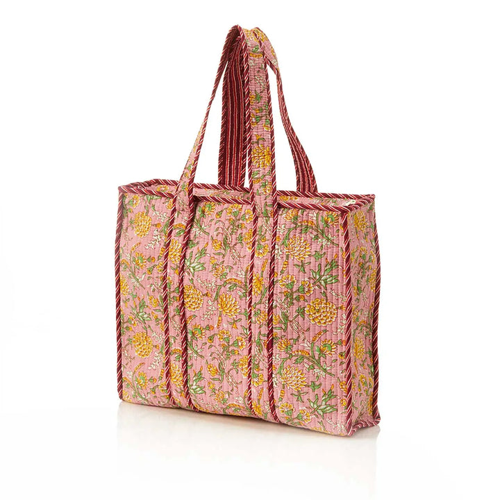 Floral patterned tote bag with pink straps on a white background