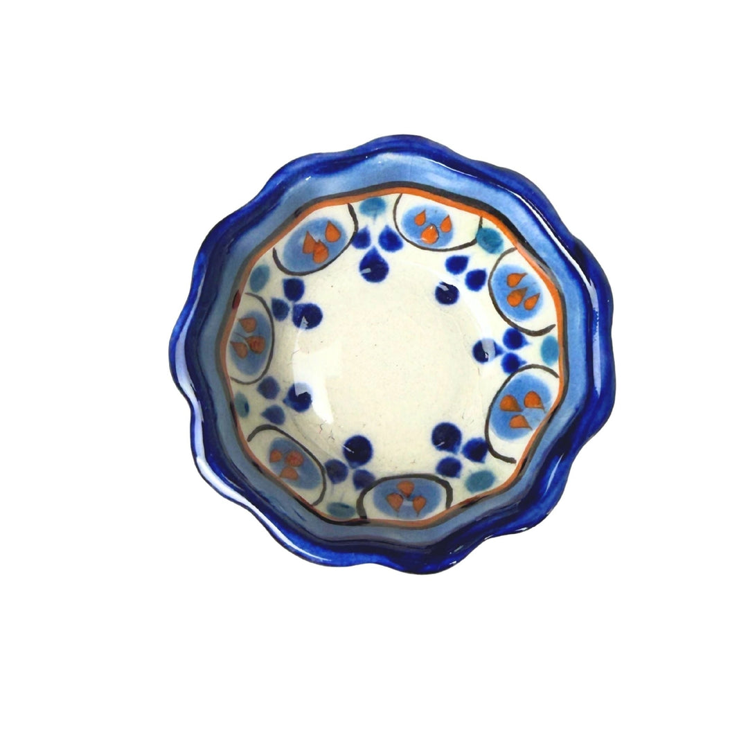 Ceramic bowl with blue and orange floral pattern on a white background