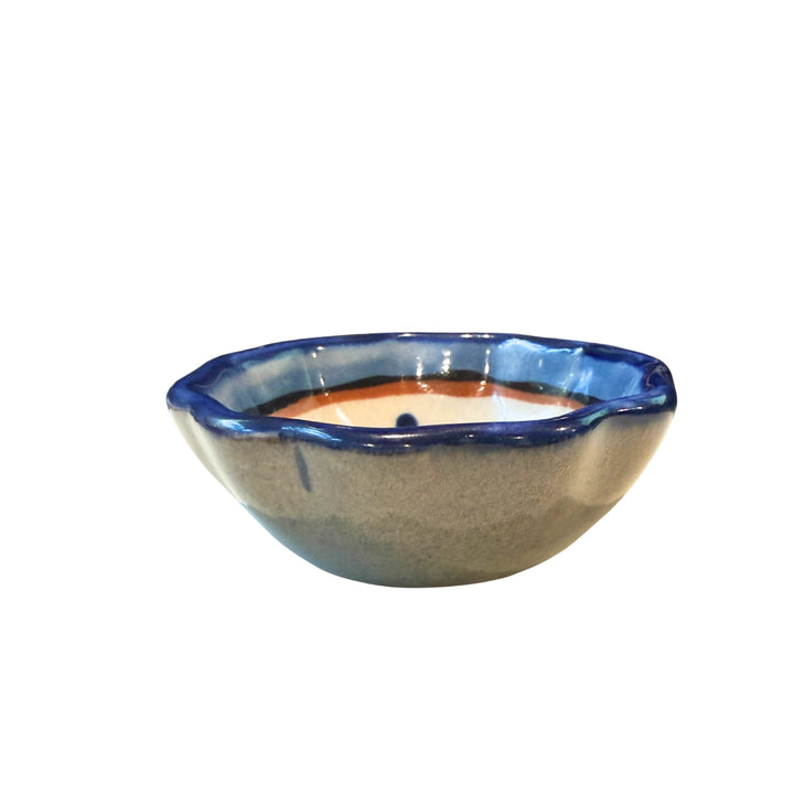Ceramic bowl with blue rim on a white background