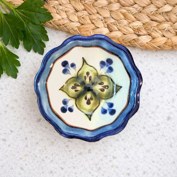Ceramic dish with floral design on a textured surface