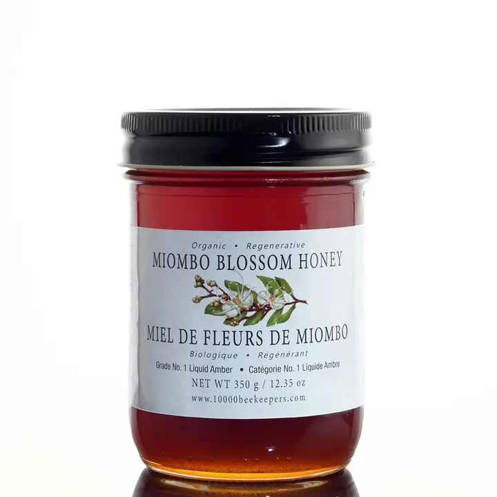 big jar of miombo blossom honey on a white background