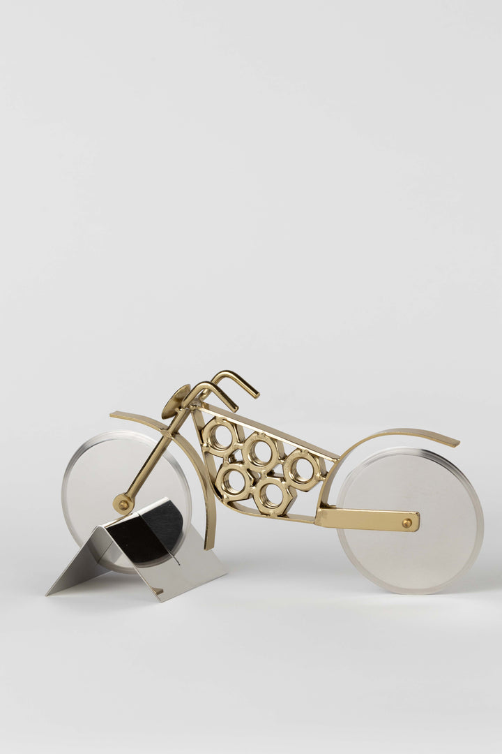 Stainless steel and brass motorcycle pizza cutter  on a white background