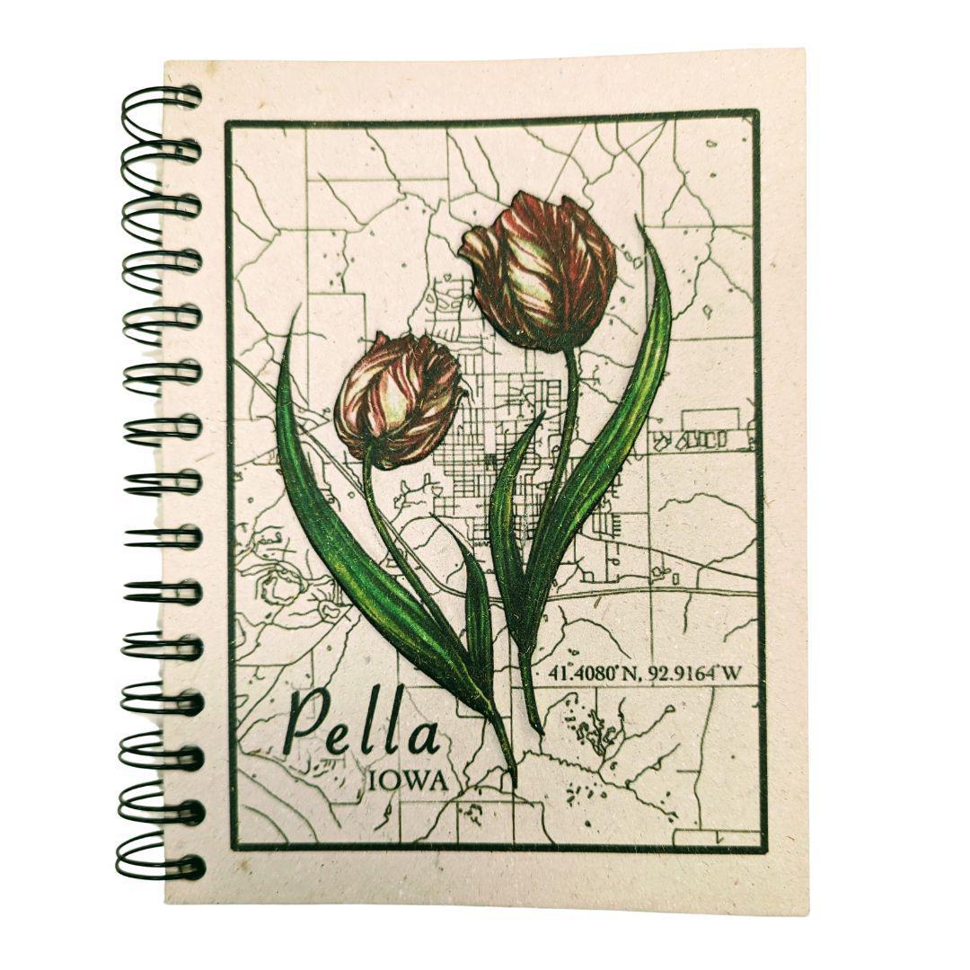 A large spiral journal with a tulip and map design on the cover, labeled 'Pella Iowa'.