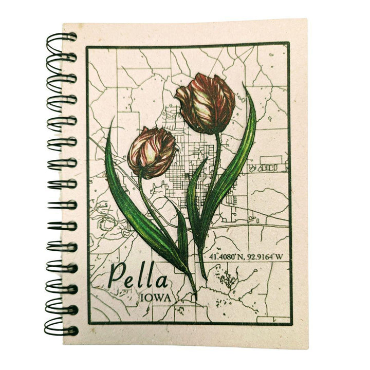 A large spiral journal with a tulip and map design on the cover, labeled 'Pella Iowa'.