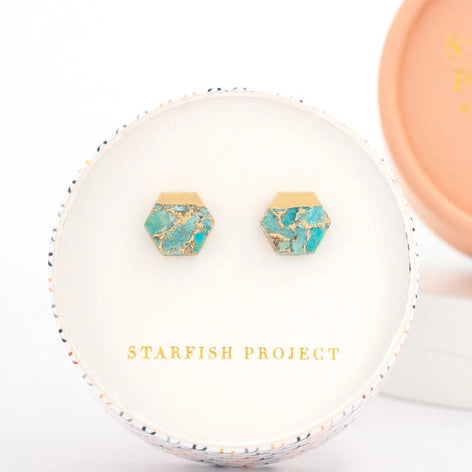 Turquoise earrings with gold accents in a 'Starfish Project' jewelry box on a white background
