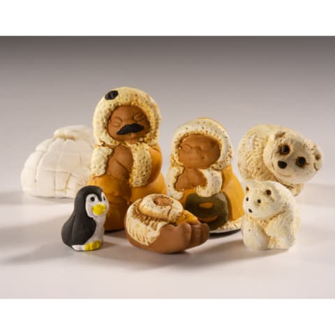 A set of arctic-themed nativity including a penguin, polar bears, and three Inuit figures with a baby, displayed on a neutral studio background.