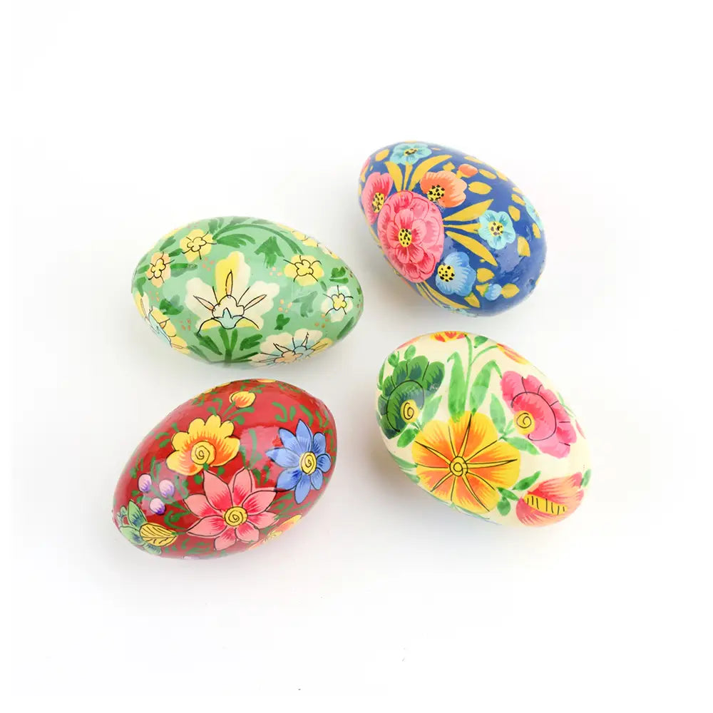 Four colorful decorated Easter eggs with floral patterns on a white background