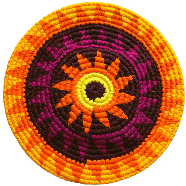 Round flying disk with a sun design in orange, purple, and yellow on a white background