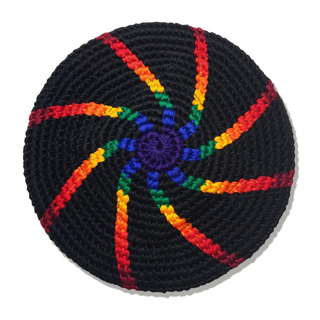 Black crocheted flying disk with rainbow-colored yarn patterns on a white background