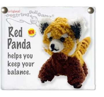 A crocheted red panda string doll on a white sign with text reading 'Red Panda helps you keep your balance.' and a small 'NEW' badge.