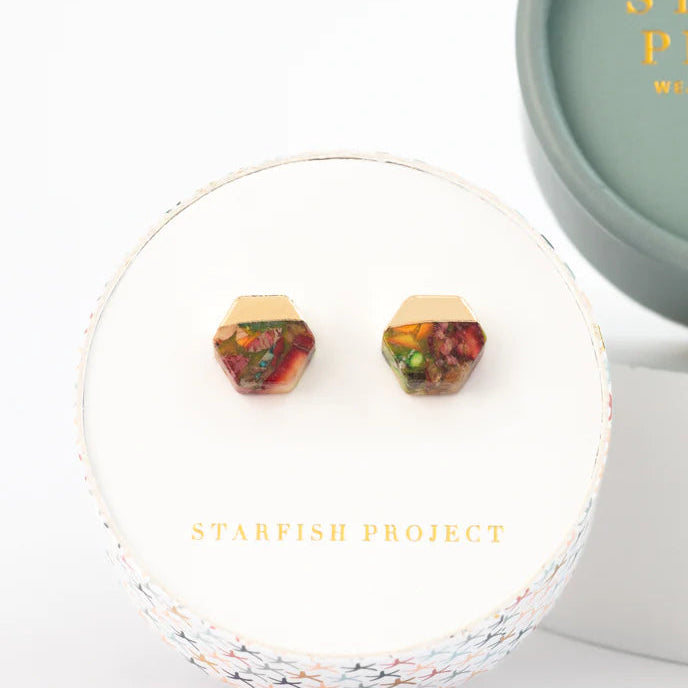 Colorful geometric earrings in a 'Starfish Project' box on a white background