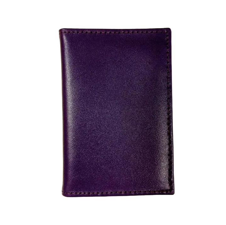 Purple leather wallet on a light beige background