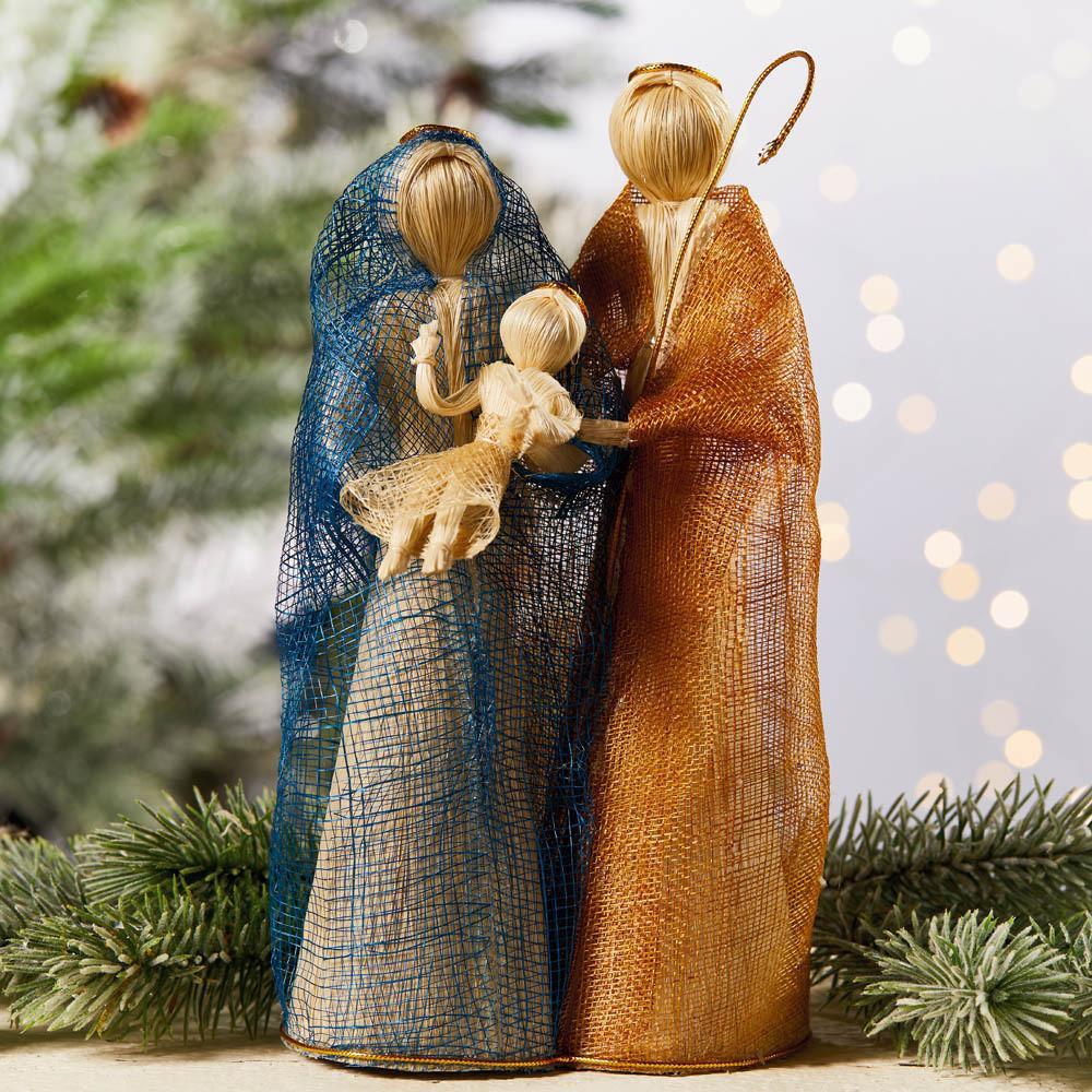 Decorative nativity scene with three figures against a festive background