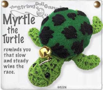 String doll turtle with a gold bell on a white background, featuring text about the turtle.