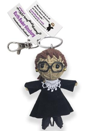 A handmade thread doll keychain featuring a character with brown hair, black glasses, a black dress, and a white lace collar, attached to a silver metal clasp with a branded paper tag.
