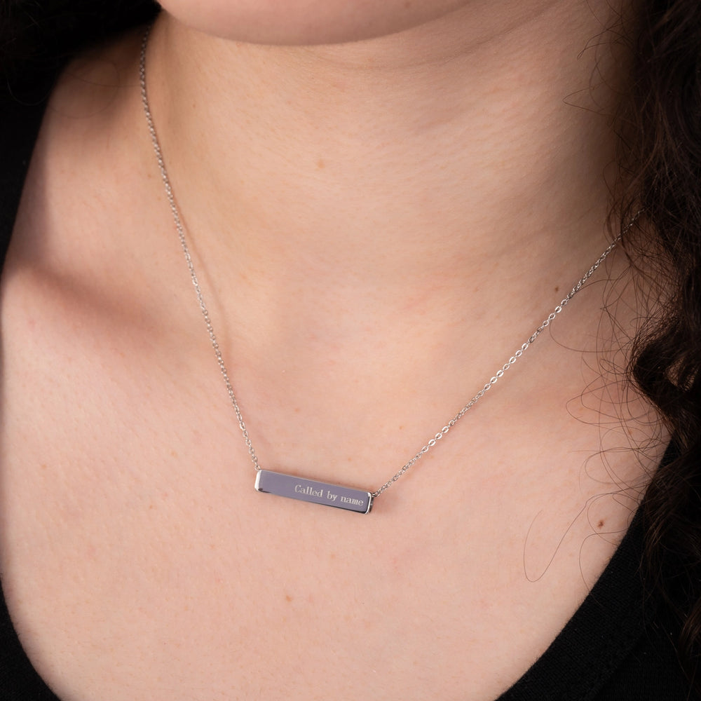 Necklace with a bar pendant on a person's neck
