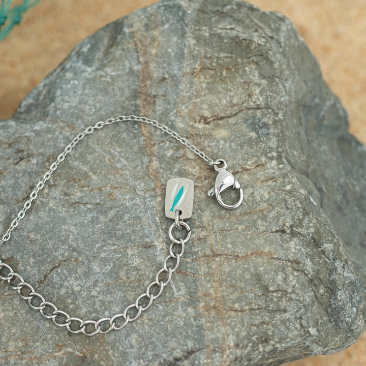 Silver necklace with a clasp on a rock