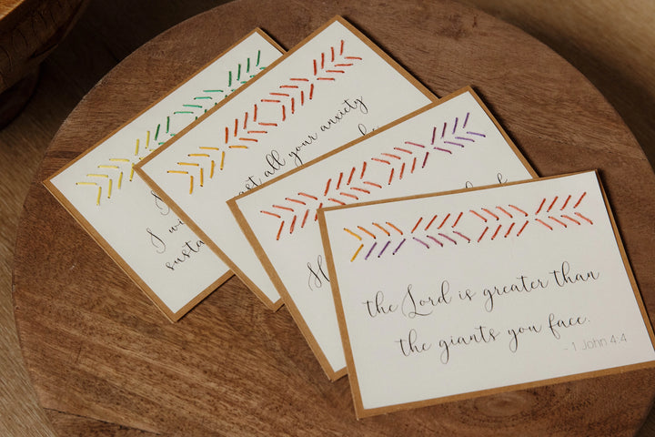 Set of cards with decorative designs and text on a wooden surface