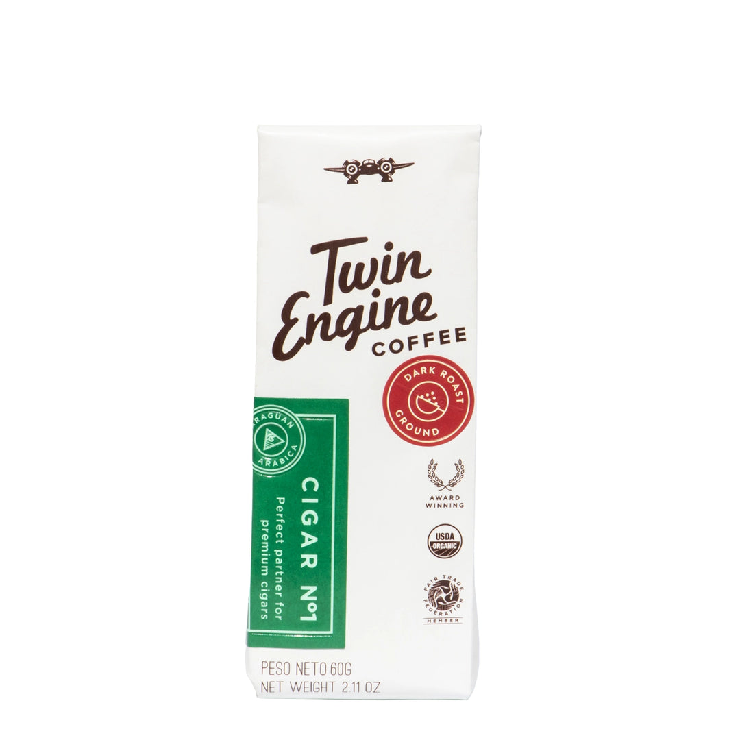 A 60g package of Twin Engine Coffee Cigar No. 1, featuring a white background with brown lettering, a green vertical label, and a red 'Date Born Ground' seal.