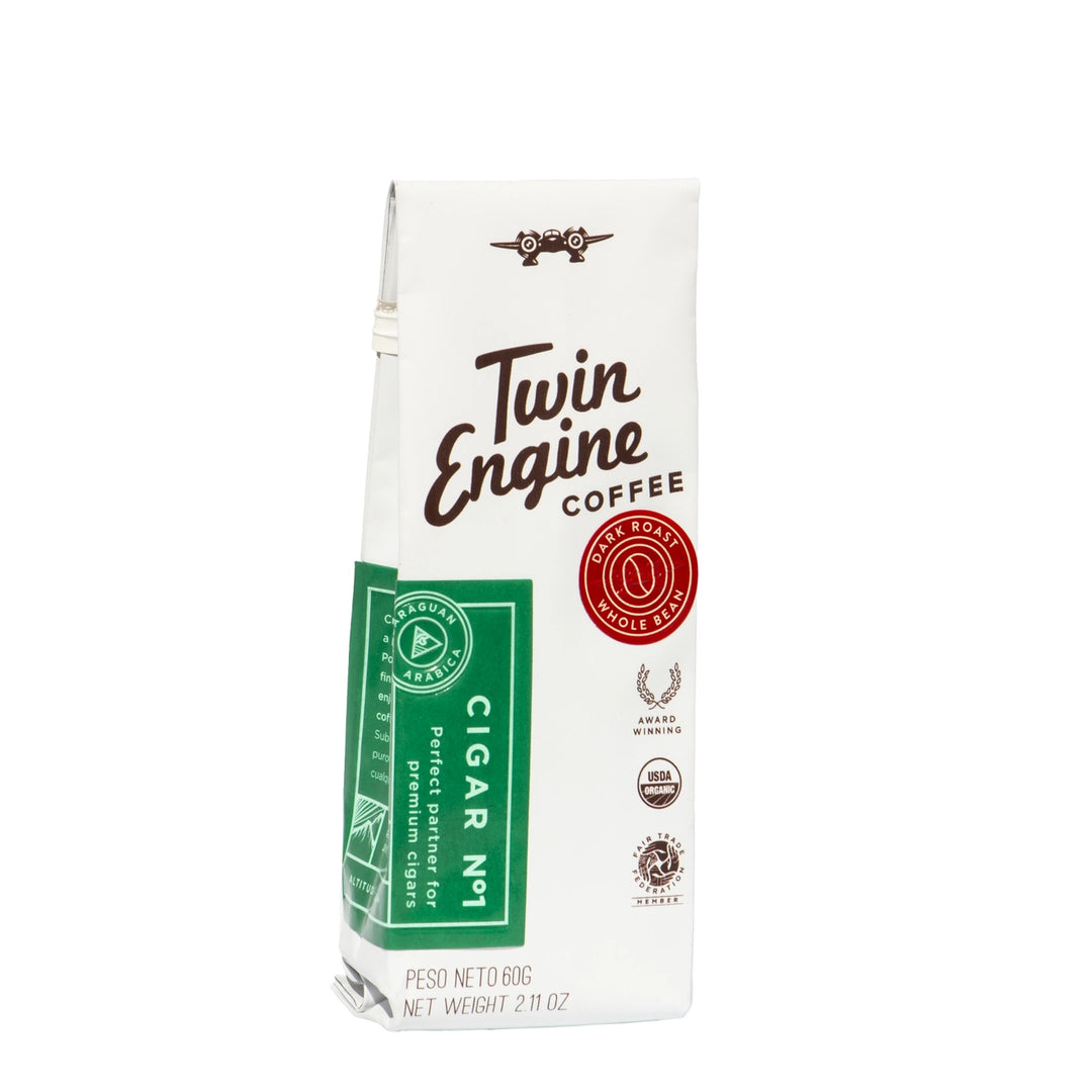 A 2 fl oz bag of Twin Engine Coffee Cigar No. 1, featuring a white package with brown script lettering, a green side label, and a red circular seal, set against a plain white background.