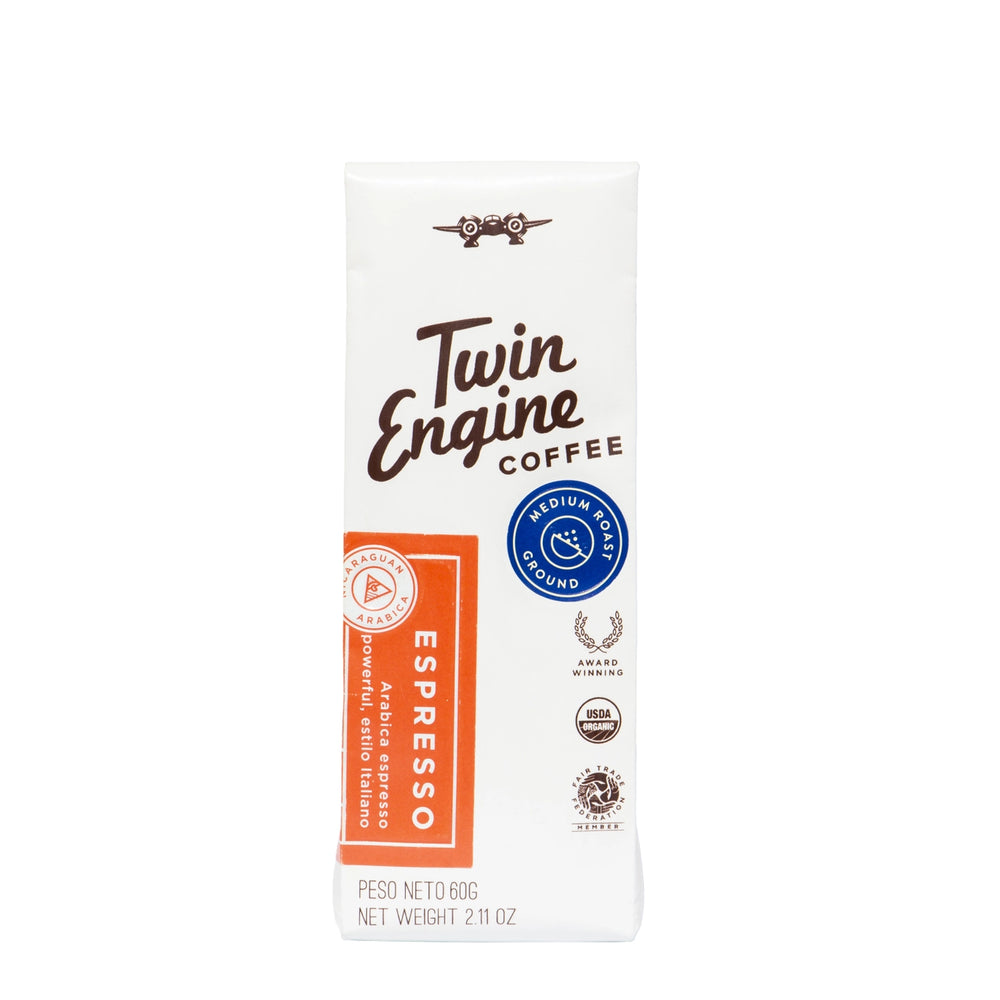 A single pack of Twin Engine Coffee Espresso on a plain white background. The packaging is primarily white with brown text, a blue circular seal, and an orange vertical label on the left side.