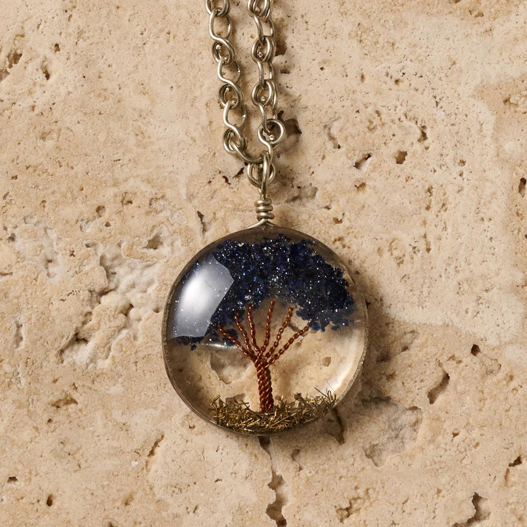 Tree of Life Necklace with a round pendant featuring a tree design on a beige stone background