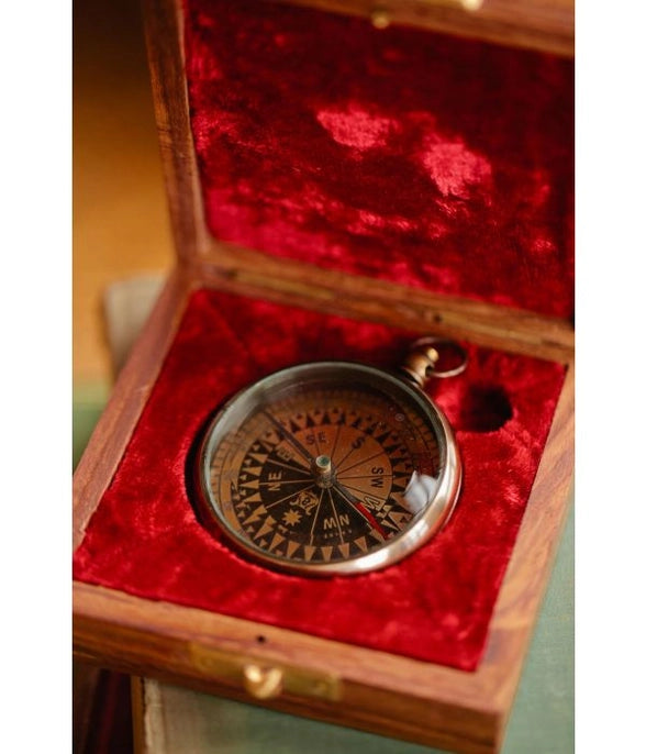 Vintage-style compass in a wooden box with red interior