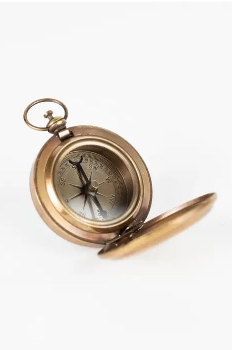 Vintage brass pocket compass on a white background