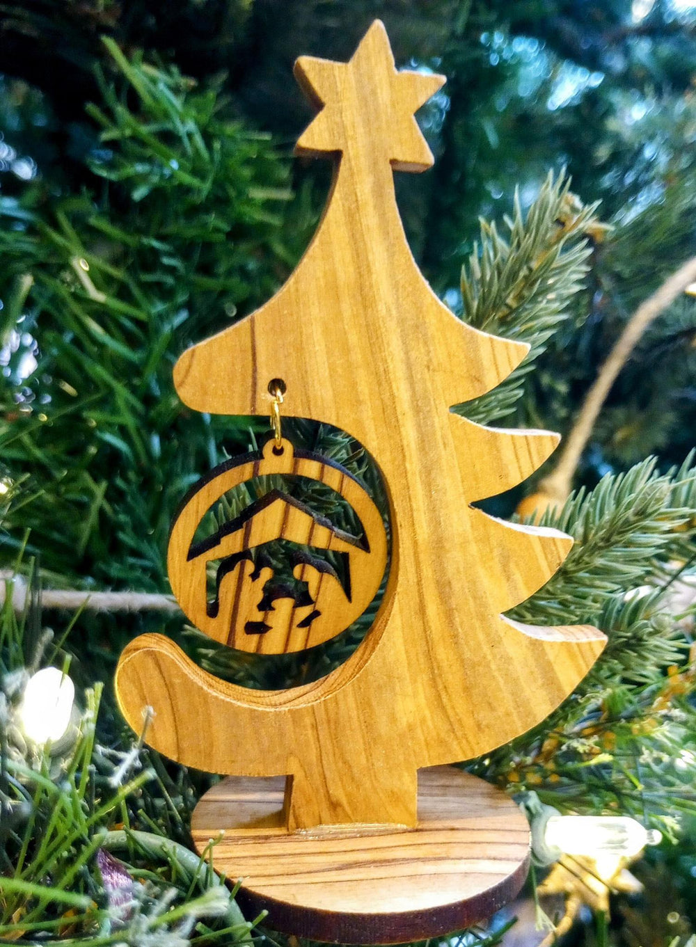 Olive wood nativity with a christmas tree background