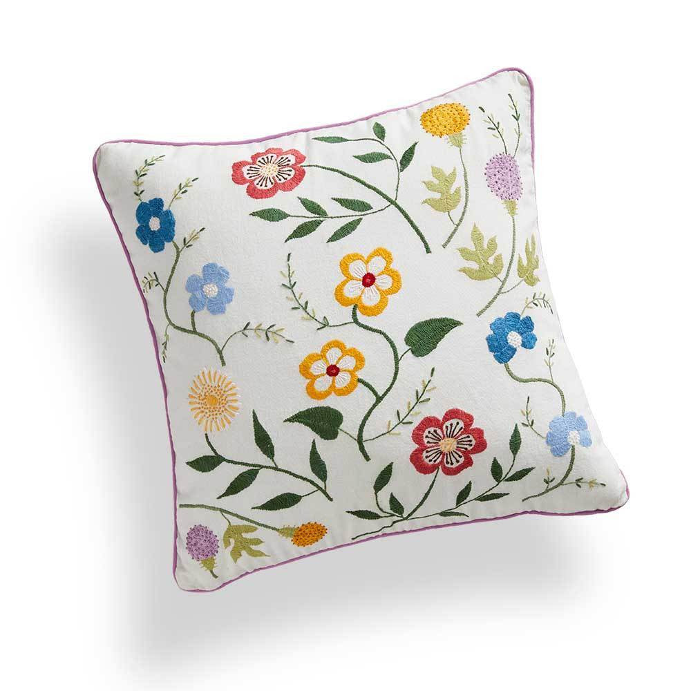Decorative pillow with floral embroidery on a white background