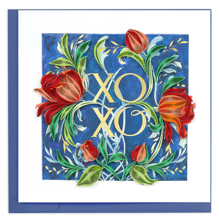 Quilled greeting card with 'XOXO' surrounded by floral designs on a blue background