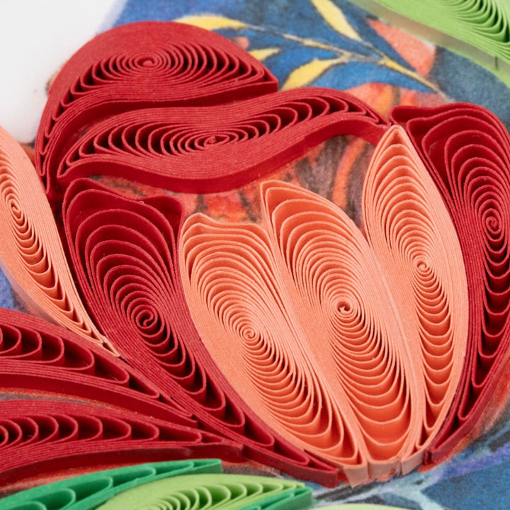 Colorful paper quilling strips arranged in a circular pattern on a textured surface.
