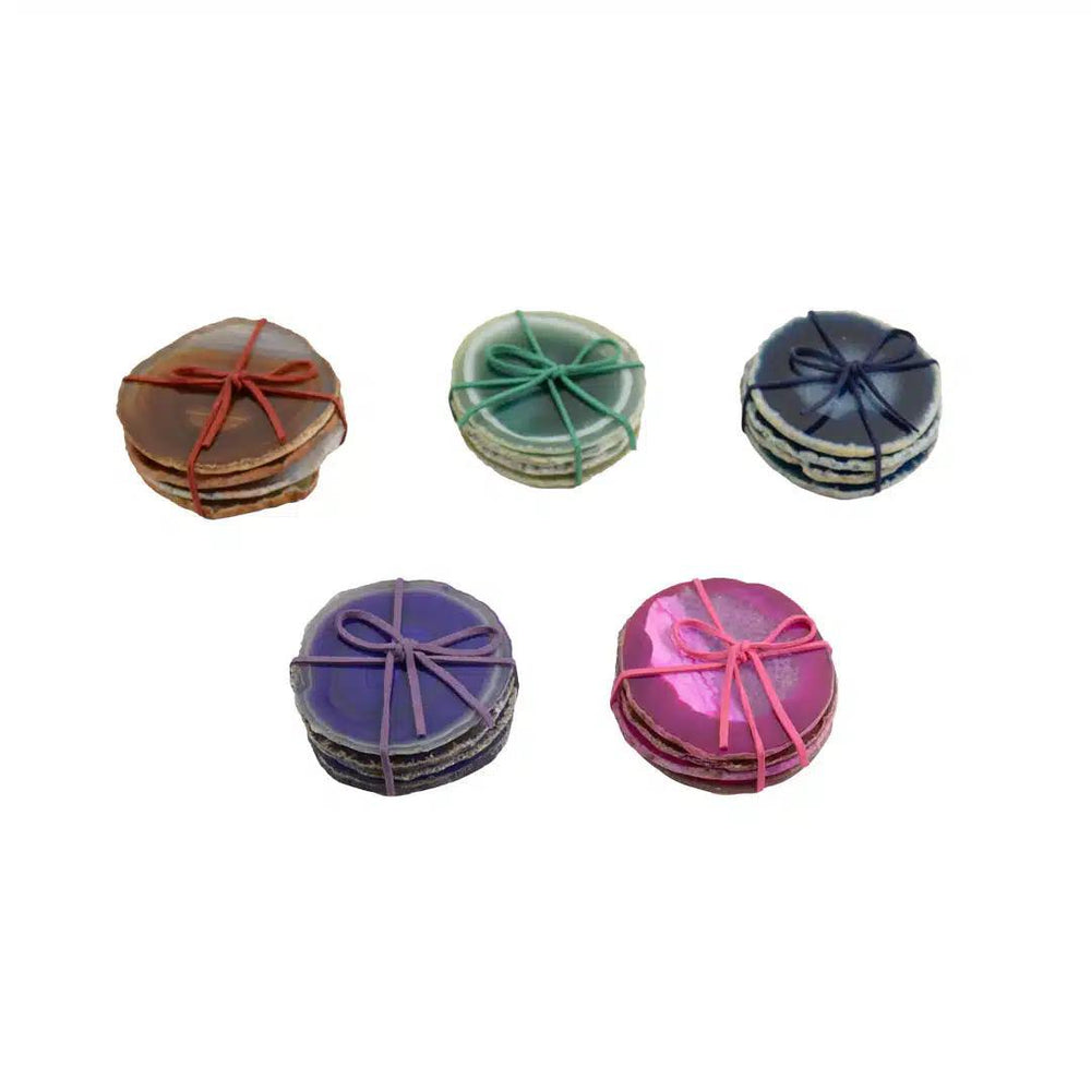 Five sets of round agate coasters with colorful ribbons on a white background