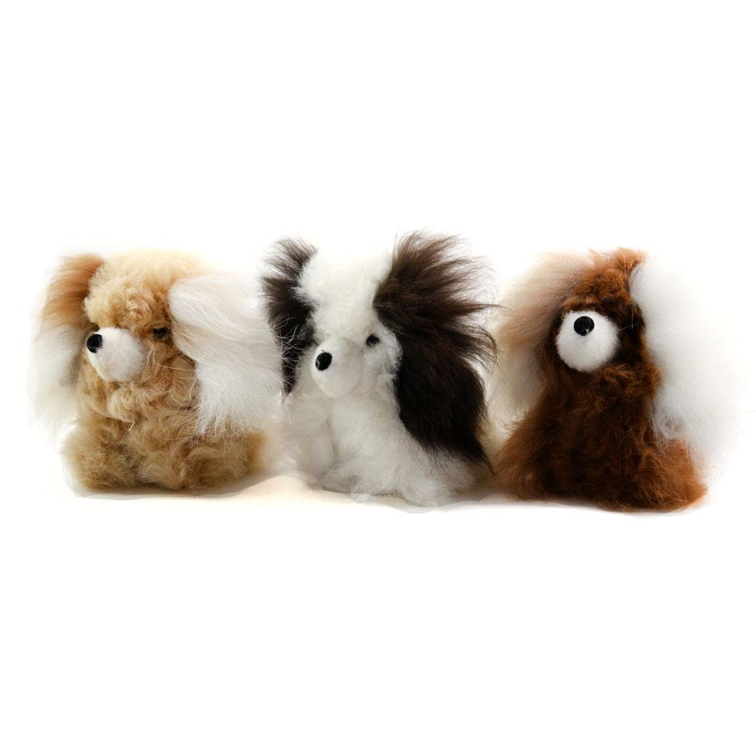 Three alpaca plush toys resembling dogs on a white background