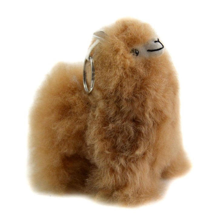 Plush alpaca toy with a keychain on a white background