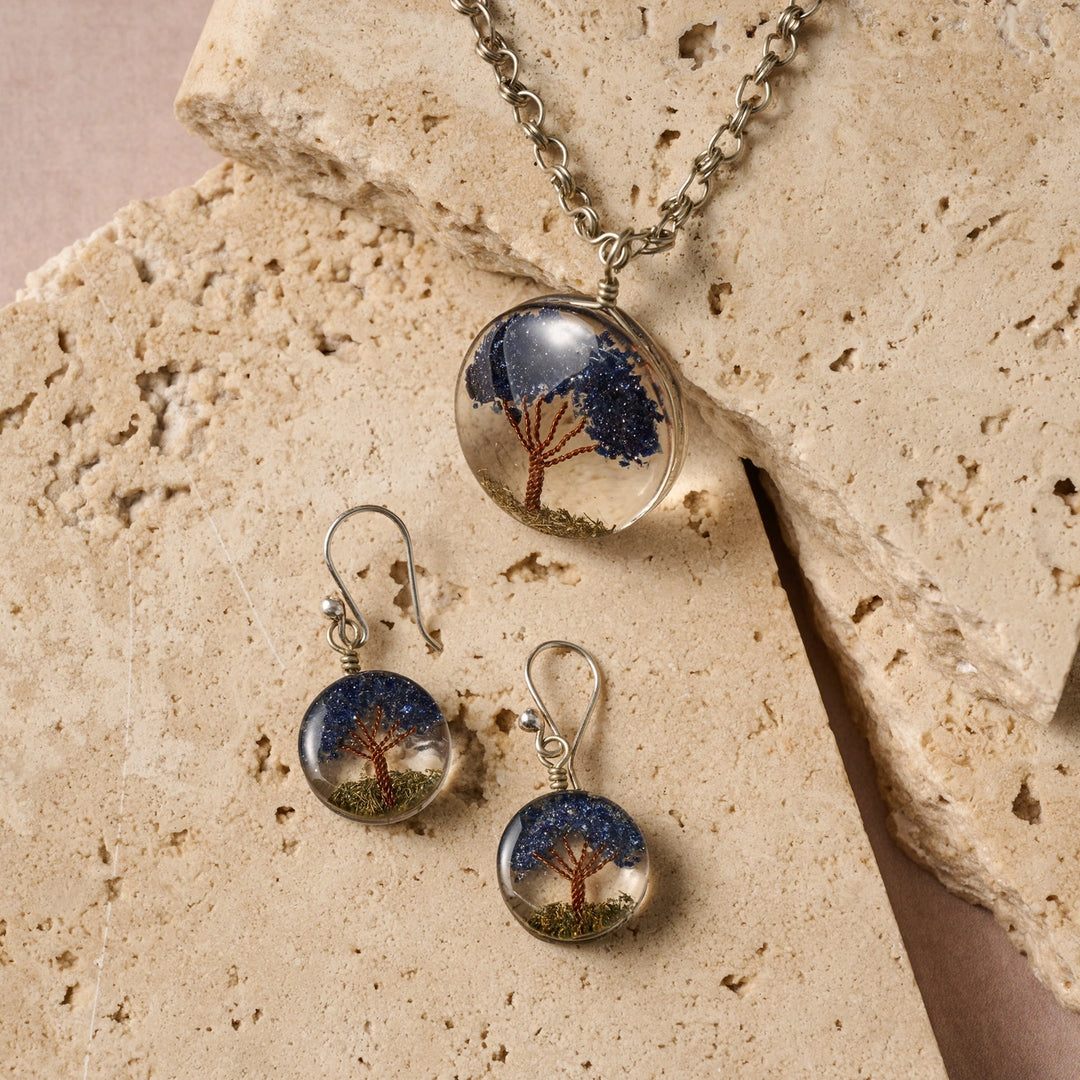 Jewelry set with tree design on a stone surface