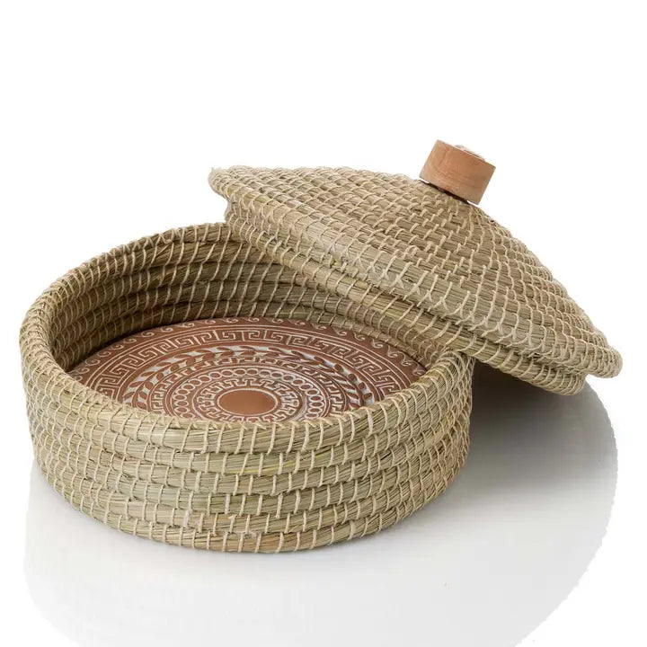 Woven basket with a lid on a white background