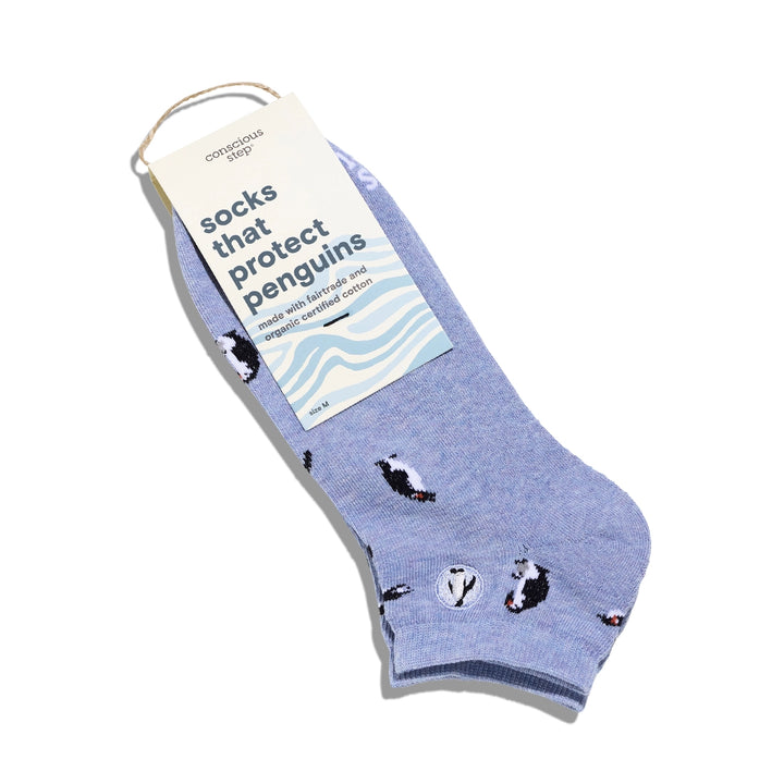 Blue sock with penguin design and 'socks that protect penguins' label on a white background
