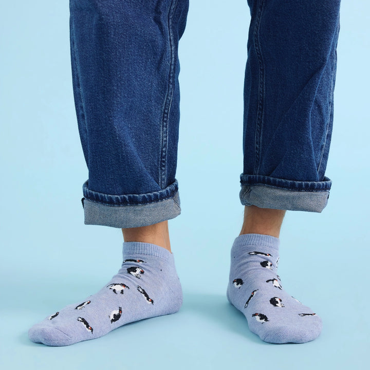 person wearing blue ankle socks with penguins