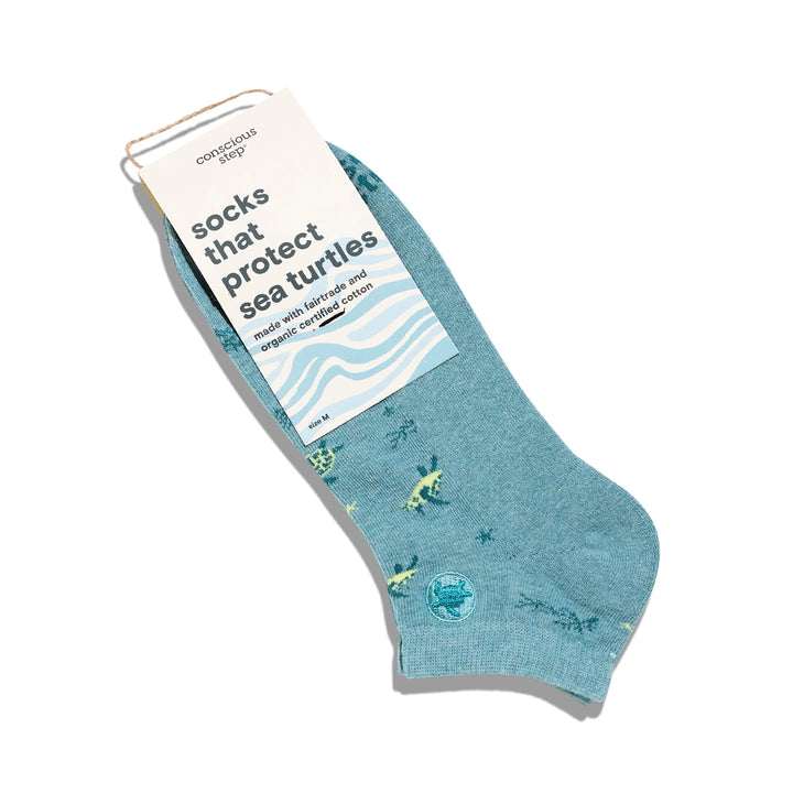 Blue socks with sea turtle design and packaging on a white background