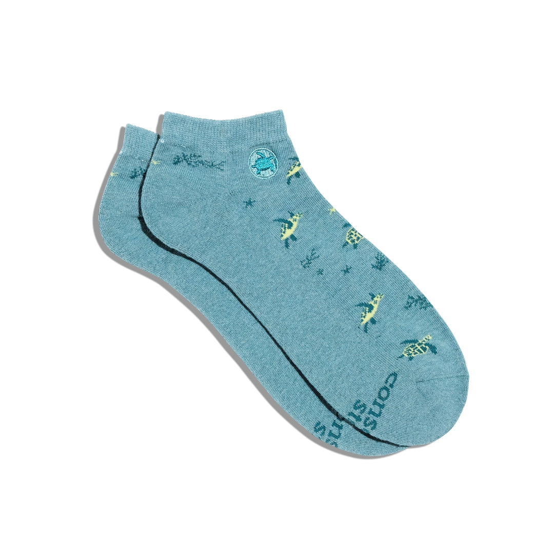 Blue ankle sock with sea turtle designs on a white background.