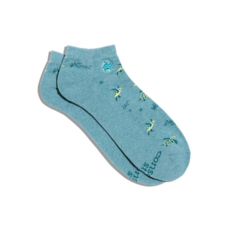 Blue ankle sock with sea turtle designs on a white background.