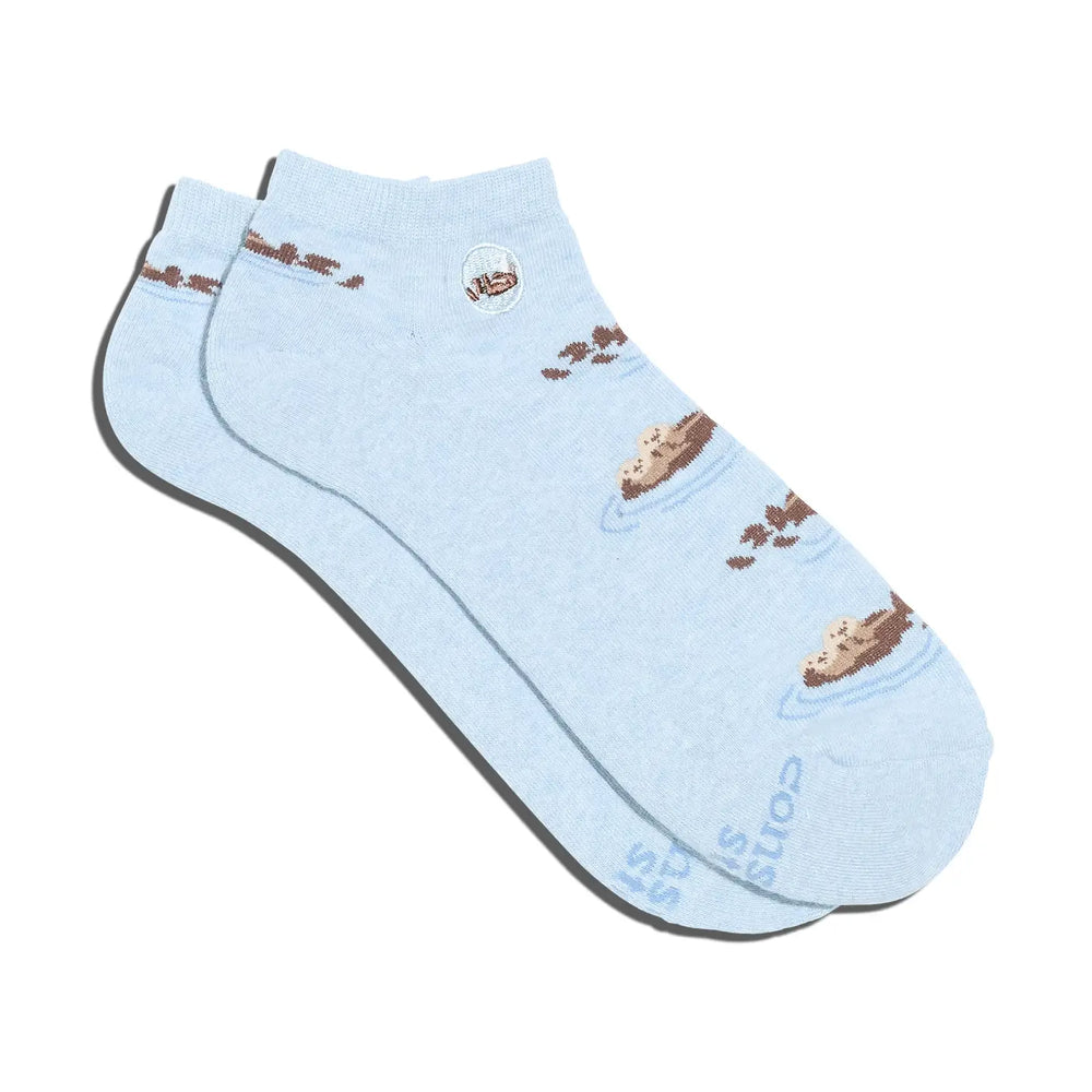 Light blue sock with brown sea otters on a white background