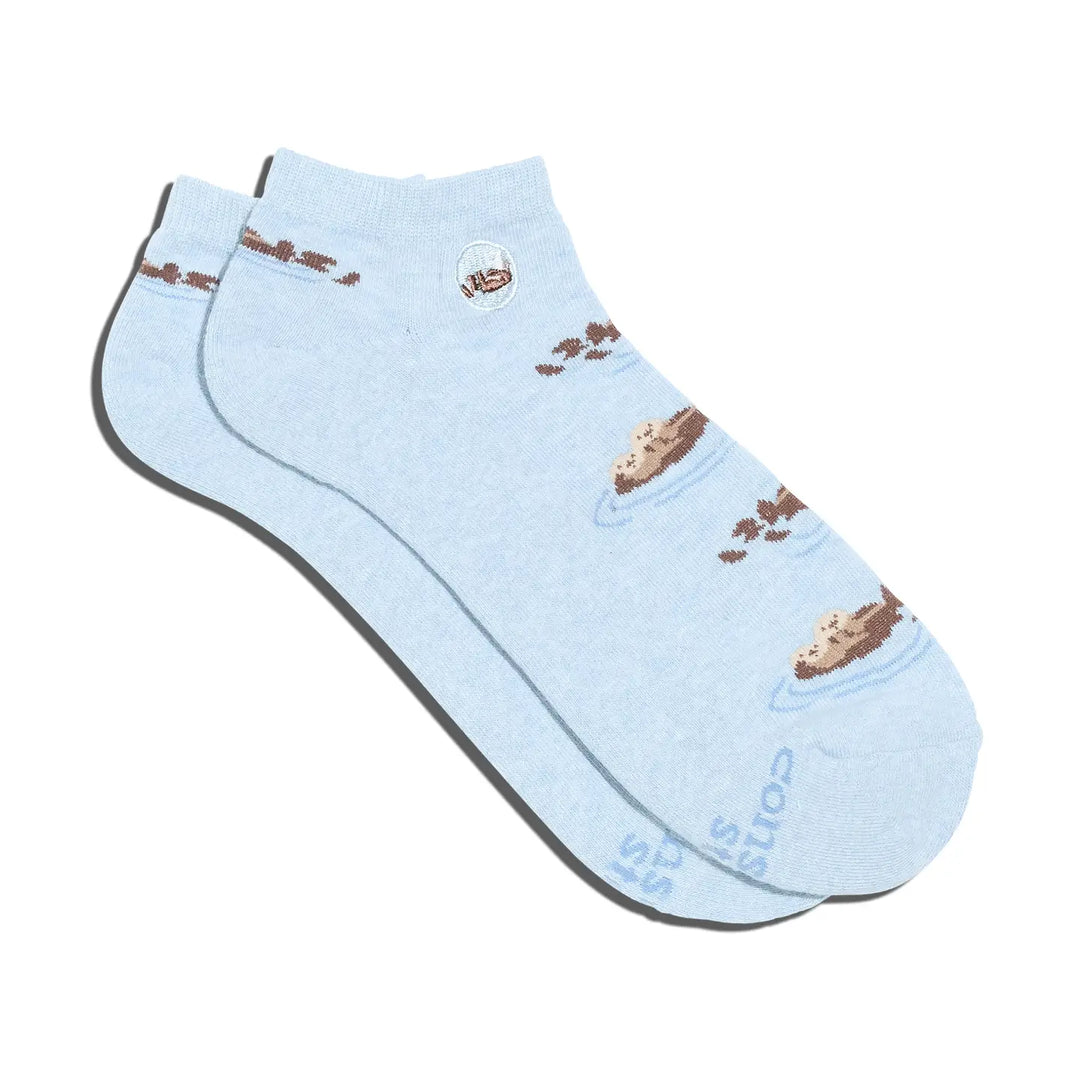 Light blue sock with brown sea otters on a white background