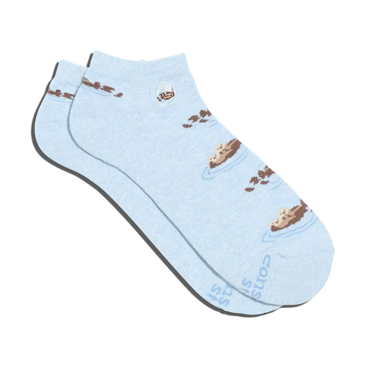 Light blue sock with brown sea otters on a white background