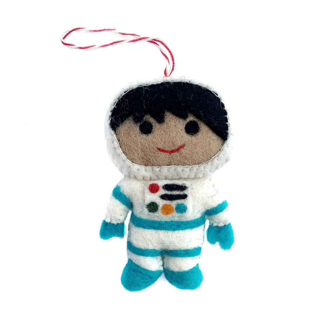 Small plush toy astronaut with a white helmet and blue suit on a white background