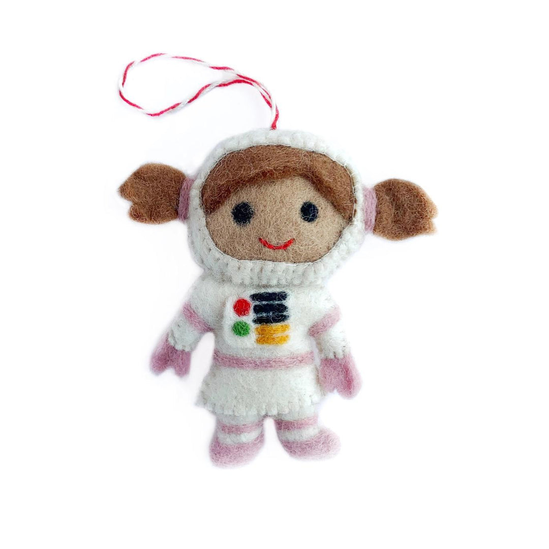 Small plush toy astronaut with a white helmet and pink suit on a white background