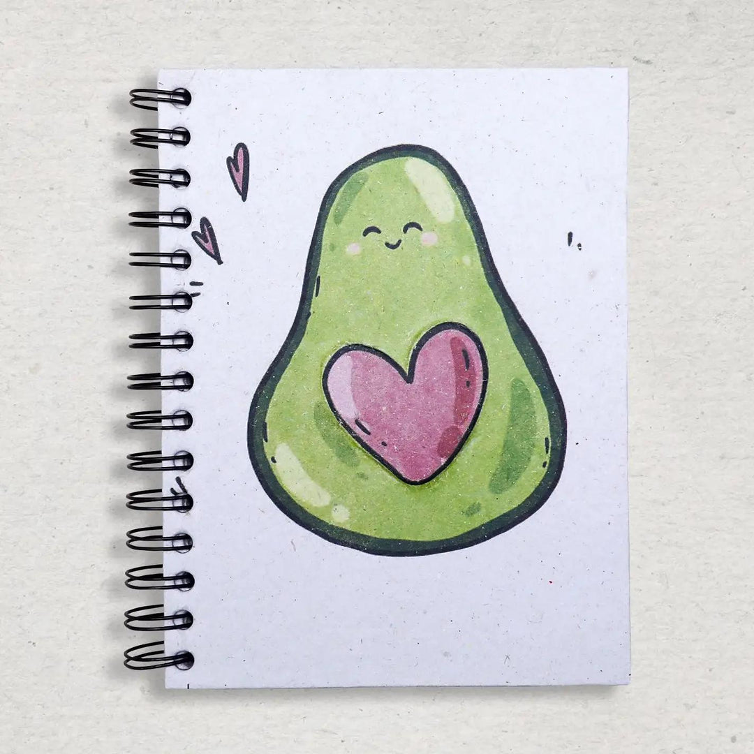 Mr. Ellie Pooh notebook with a cute avocado illustration featuring a heart on a textured surface