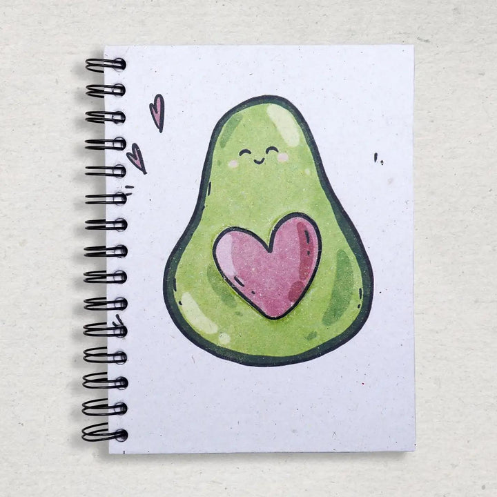 Mr. Ellie Pooh notebook with a cute avocado illustration featuring a heart on a textured surface